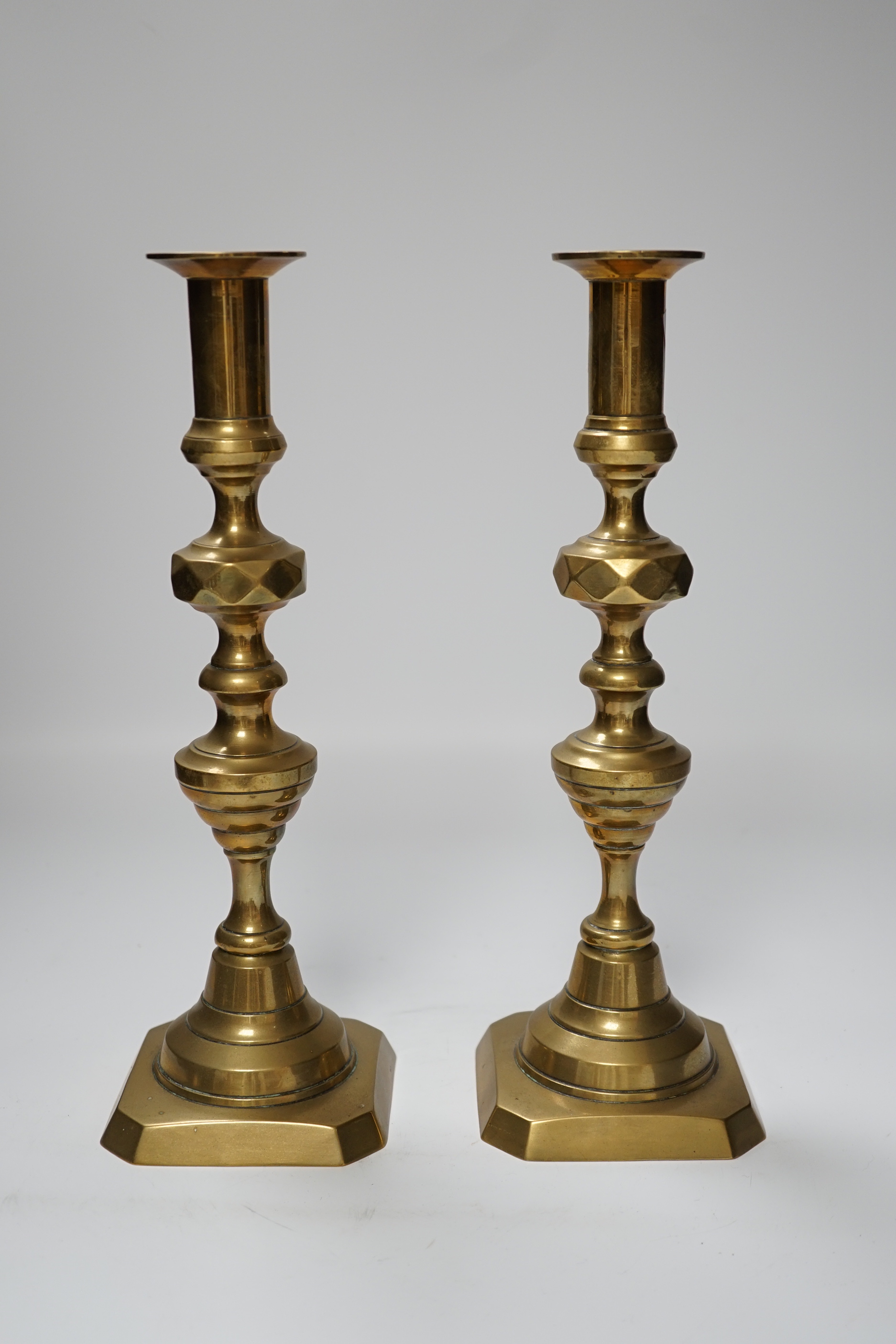 A pair of 19th century brass candlesticks, 30cm